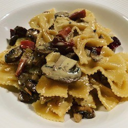 Farfalle with brown mushrooms and speck